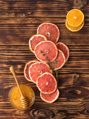Dried slices of orange on wooden background.