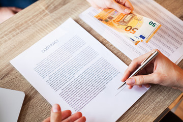 Obraz premium Human in the office receives the bribe for signing the contract.