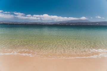 landscape in Opossum Bay Beach on a sunny summer day with nobody on the beach with deep blue water...