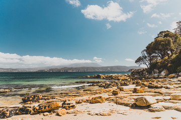 landscape in Opossum Bay Beach on a sunny summer day with nobody on the beach with deep blue water...