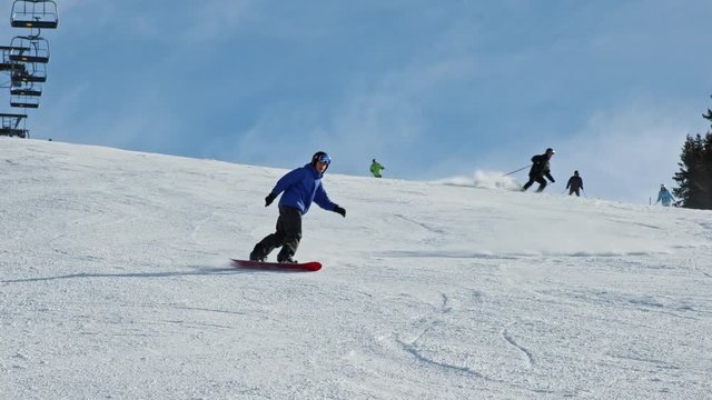 Teenage boy snowboarding on the slope.