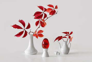 white dishes and red leaves