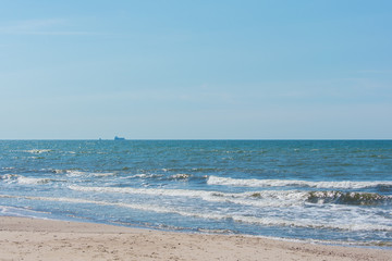 Fototapeta na wymiar Beach landscape with steep dune coast blue sky Liepaja Skede Latvia