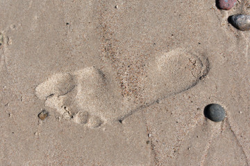 Single bare foot imprint in beach sand