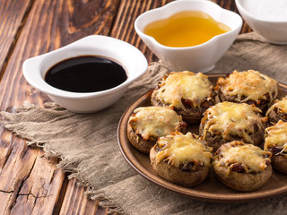 Baked mushrooms in the oven with cheese and vegetables.