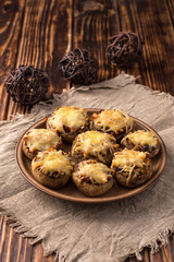 Baked mushrooms in the oven with cheese and vegetables.