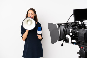 Reporter woman holding a microphone and reporting news isolated on white background shouting through a megaphone