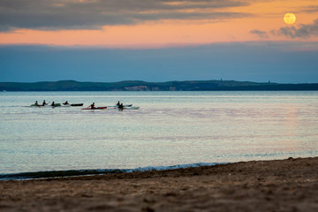 Ocean kayaking at sunset