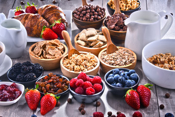 Different sorts of breakfast cereal products and fresh fruits