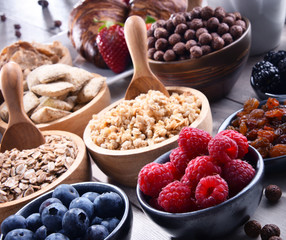 Different sorts of breakfast cereal products and fresh fruits