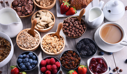 Different sorts of breakfast cereal products and fresh fruits