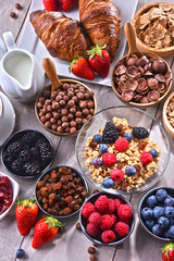Different sorts of breakfast cereal products and fresh fruits
