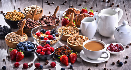 Different sorts of breakfast cereal products and fresh fruits