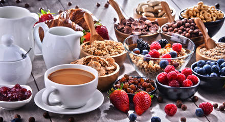 Different sorts of breakfast cereal products and fresh fruits