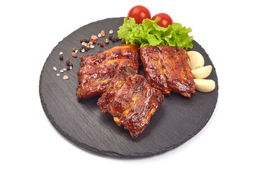 Delicious spicy marinated ribs in a bbq or tomato sauce, isolated on white background