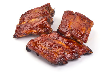 Delicious grilled pork ribs in BBQ, isolated on white background