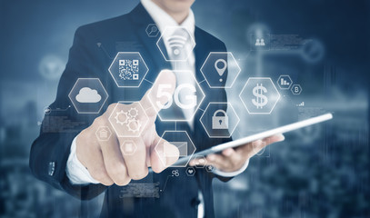 5G internet networking, big data and blockchain technology. Businessman pressing 5G on virtual reality screen with application icons 