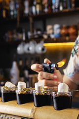 Burn marshmallows over rum and coffee cocktail