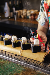 Burn marshmallows over rum and coffee cocktail