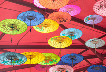 Fototapeta na wymiar Colorful oil-paper umbrellas hanging in the air
