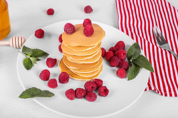 Tasty american pancakes with raspberries and honey. Top view, close up, colorful