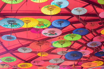 Fototapeta na wymiar Colorful oil-paper umbrellas hanging in the air