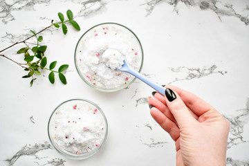 Set of cosmetics for women's skin and body care, sea salt on a gray marble background. Beauty...