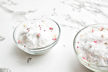 Set of cosmetics for women's skin and body care, sea salt on a gray marble background. Beauty blogger, concept of salon procedures. Flat lay, top view