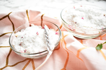 Set of cosmetics for women's skin and body care, sea salt on a gray marble background. Beauty blogger, concept of salon procedures. Flat lay, top view