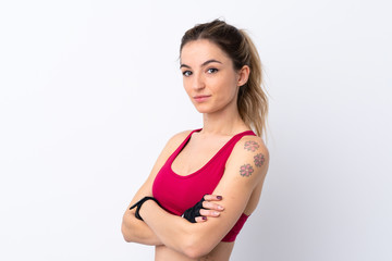 Young sport woman over isolated white background keeping the arms crossed