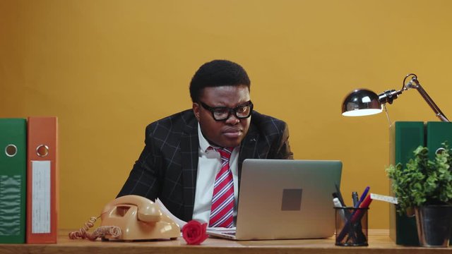 Shocked stressful black african executive finds failure mistake in his work sitting in frustration taking off his glasses looking at camera. Office people. Problems.