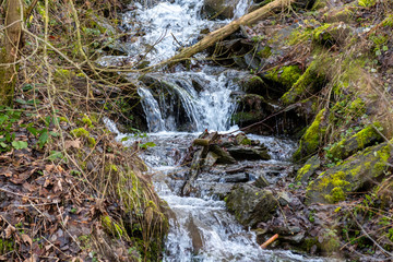 Flowing water and small waterfall on a hill in Monschau