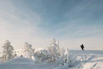 Portrait of snowboarder with board  in snowy winter landscape outdoors