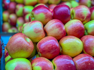 Heap of apples for sale at fruit stall in supermarket