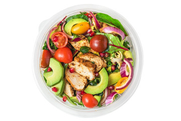 Healthy chicken salad in plastic package for take away or food delivery isolated on a white background
