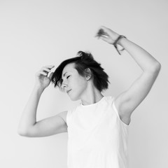 Woman dancing raising her hands, black and white photo