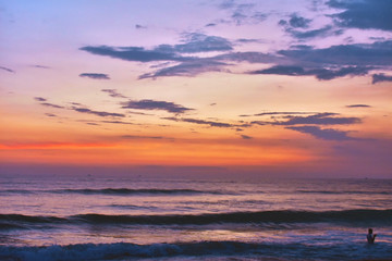 Obraz na płótnie Canvas beautiful small waves with a reddish sky over the ocean