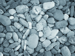 Naturally polished white rock pebbles backgroundNaturally polished white rock pebbles background