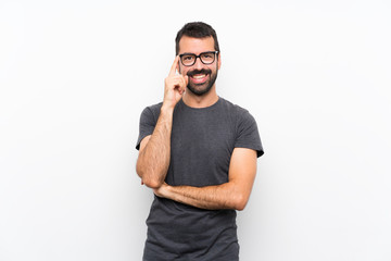 Young handsome man over isolated white background with glasses and happy