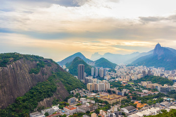 Rio De Janeiro Amazing View, Sugar Loaf Mountain, Urca Hill, Evening Clouds, Sunset. Buildings, City Center, Jesus Redeemer Statue And Tropical Rainforest Hills In Brazil.