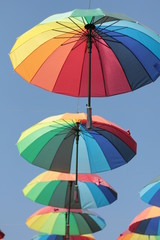 colorful umbrella hang on the air with blue sky background
