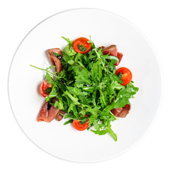 Fresh salad in a plate on a white background. The view from a top.
