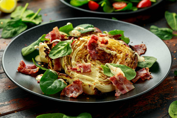 Oven roasted cabbage steaks with bacon, spinach and mayonnaise. healthy food