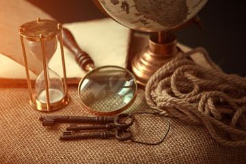 Old vintage items of the treasure hunter, traveler and discoverer - a magnifying glass, old...