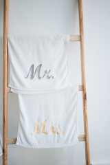 Fototapeta na wymiar Towel for couple 'Mr and Mrs' hang on wooden ladder
