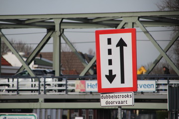 Warning sign at the steel lift bridge of Waddinxveen that ships will navigate on two directions under the bridge