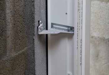 fastening a plastic window to the wall in level