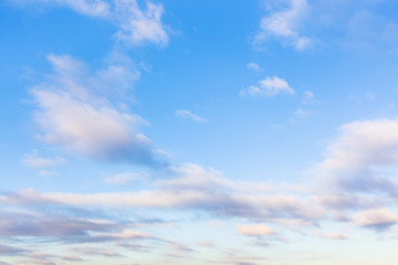 low clouds in blue sky in evening twilight - obrazy, fototapety, plakaty