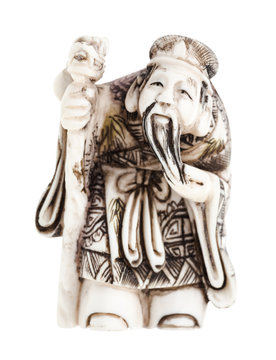 wise man with staff carved from ivory isolated