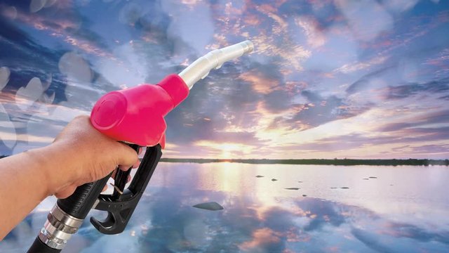 Holding a fuel nozzle against the filling nozzle a hand in his hand that separates from the bokeh background clipping part